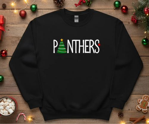 Black sweatshirt with 'PANTHERS' text on a wooden surface with Christmas decorations.